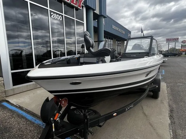 Slide: The Image of 2026 Lund 202 PRO-V GL Sport boat parked outside a building. - 5