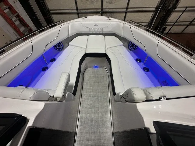 Slide: The Image of The image shows the cockpit of a Regal LS6 boat with white upholstery and blue lighting. - 5