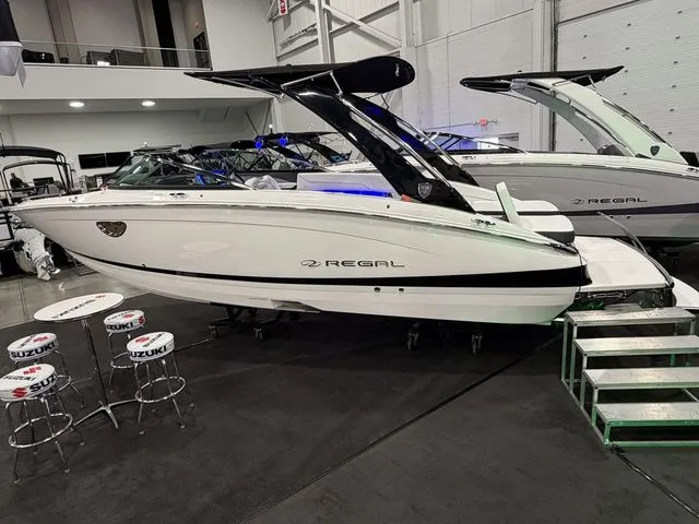 The Image of 2026 Regal LS6 boat in showroom with Suzuki bar stools. - 1