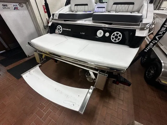 Slide: The Image of The image shows the rear of a Regal LS6 boat with a fold-out swim platform. - 2