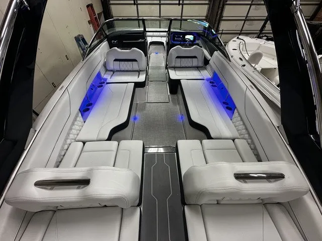 Slide: The Image of The image shows the interior of a 2026 Regal LS6 boat with sleek white seating and blue lighting. - 6