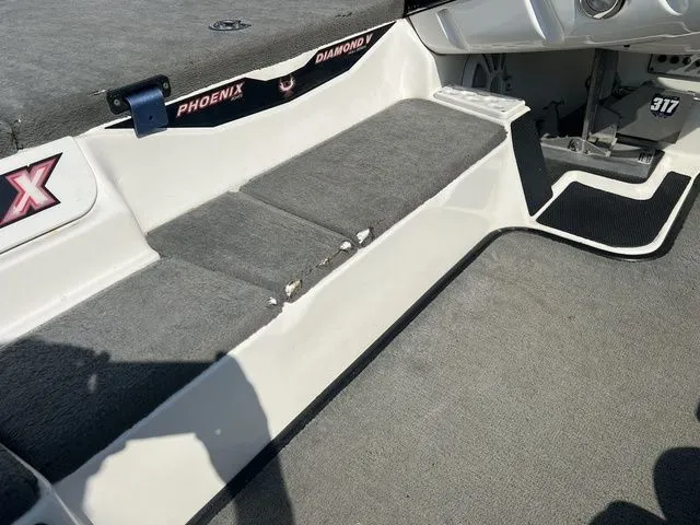 Slide: The Image of Interior of a 2010 Phoenix 721 ProXP boat with gray carpeting. - 29