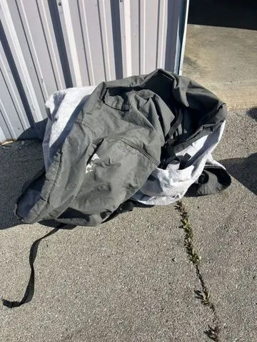 Slide: The Image of Folded tarp on concrete ground beside metal building. - 31