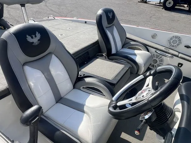 Slide: The Image of Interior of a 2010 Phoenix 721 ProXP boat with steering wheel and seats. - 7