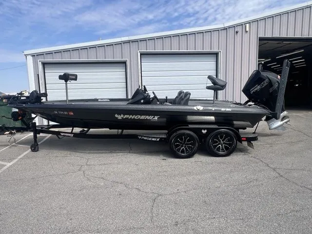 The Image of 2023 Phoenix Bass Boats 921 Elite in front of a garage. - 1