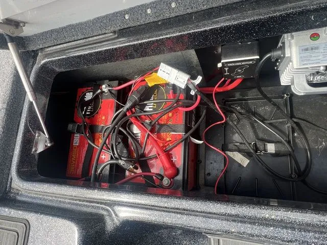 Slide: The Image of Battery compartment of 2023 Phoenix Bass Boats 921 Elite with cables. - 15