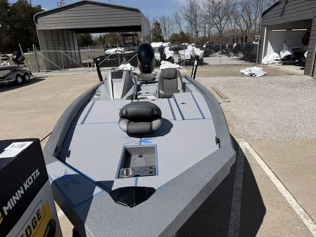 Slide: The Image of 2026 Xpress H20 boat in parking lot, gray color, Minn Kota motor. - 10