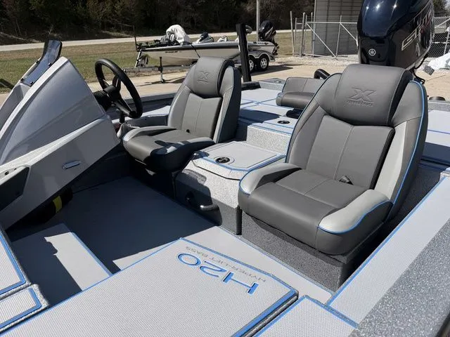 Slide: The Image of Interior of Xpress H20 boat, 2026 model, featuring gray seats. - 11