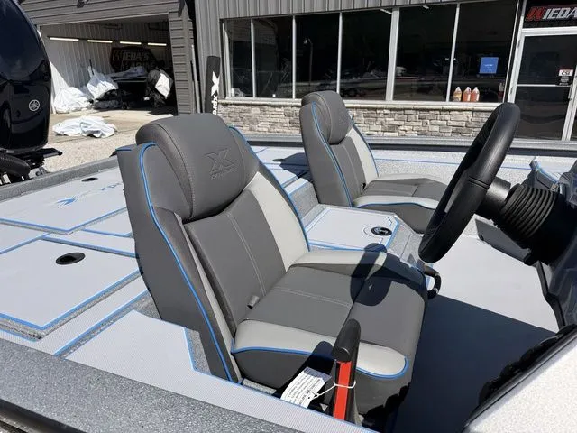 Slide: The Image of Interior of 2026 Xpress H20 boat with gray and blue seating. - 6