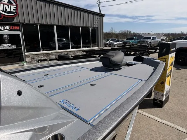 Slide: The Image of 2026 Xpress H20 boat with gray deck outside a store. - 7