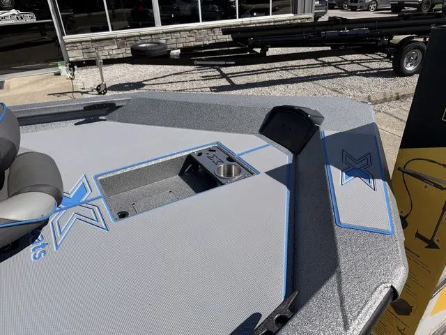 Slide: The Image of 2026 Xpress H20 boat deck with blue accents and cup holder. - 9