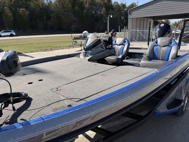 Slide: The Image of 2024 Ranger Z520R boat with blue accents on a parking lot. - 12