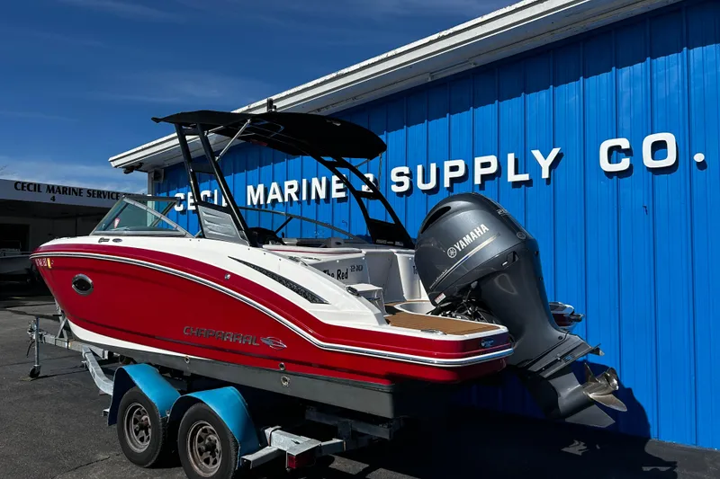 Slide: The Image of 2016 Chaparral 210 Suncoast boat with Yamaha engine at marine supply store. - 1