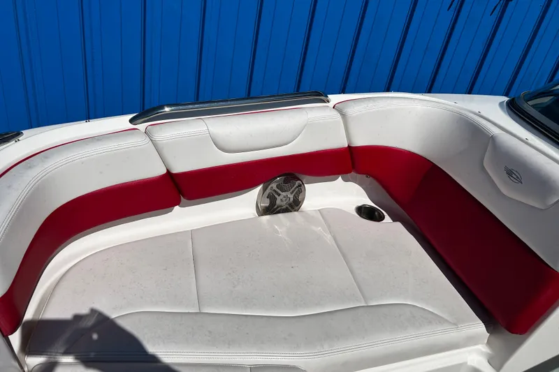 Slide: The Image of 2016 Chaparral 210 Suncoast boat interior with red and white seating. - 12