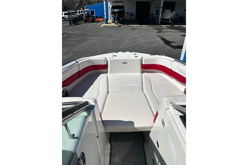 Slide: The Image of 2016 Chaparral 210 Suncoast boat interior with red and white seating. - 13