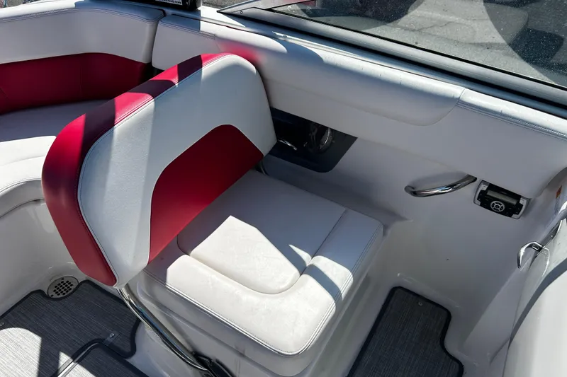 Slide: The Image of 2016 Chaparral 210 Suncoast boat interior with red and white seating. - 16