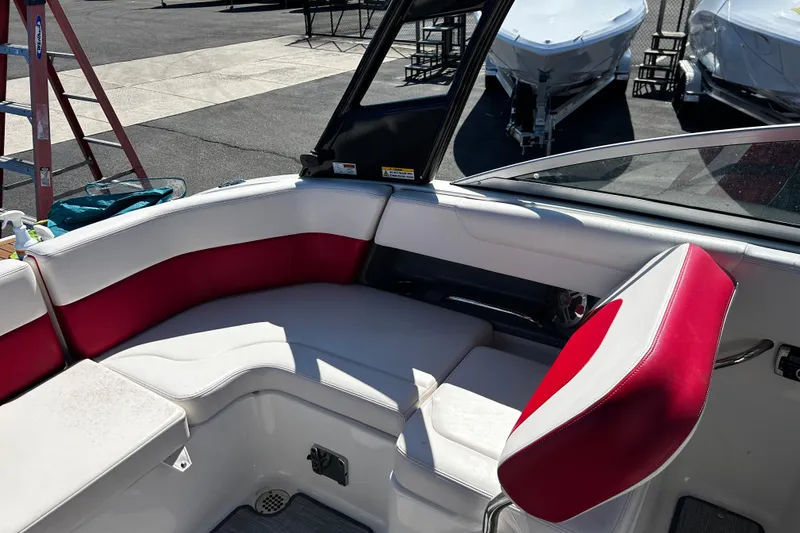 Slide: The Image of Interior of 2016 Chaparral 210 Suncoast boat with red and white seating. - 17