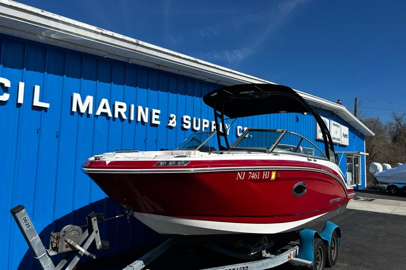 Slide: The Image of 2016 Chaparral 210 Suncoast boat on trailer outside marine supply store. - 2