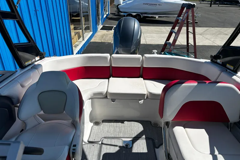 Slide: The Image of 2016 Chaparral 210 Suncoast boat interior with red and white seating. - 20