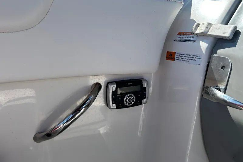 Slide: The Image of Control panel and handle on 2016 Chaparral 210 Suncoast boat interior. - 24