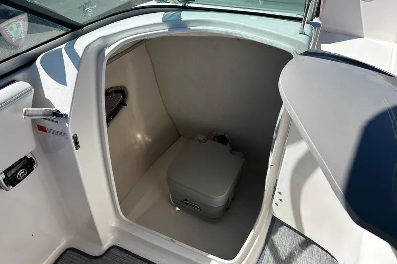 Slide: The Image of 2016 Chaparral 210 Suncoast boat interior with compact portable toilet. - 26