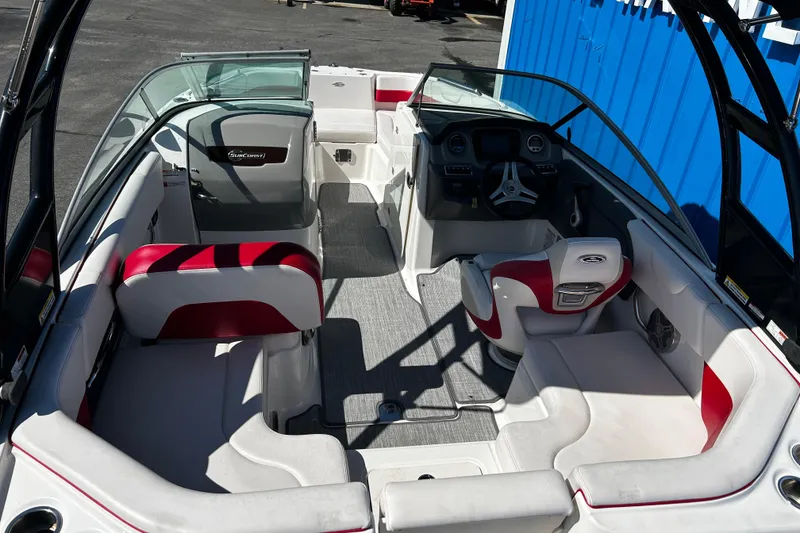 Slide: The Image of 2016 Chaparral 210 Suncoast boat interior with red and white seating, steering console. - 28