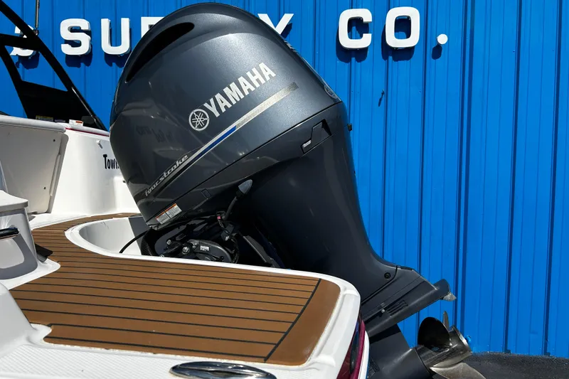 Slide: The Image of 2016 Chaparral 210 Suncoast with Yamaha outboard motor against blue background. - 32