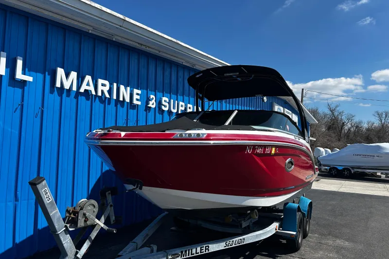 Slide: The Image of 2016 Chaparral 210 Suncoast boat on trailer, parked outside marine supply store. - 5