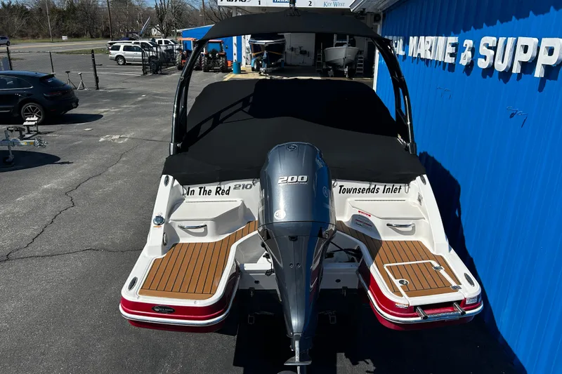 Slide: The Image of 2016 Chaparral 210 Suncoast boat with Yamaha 200 engine, docked at marine supply store. - 7