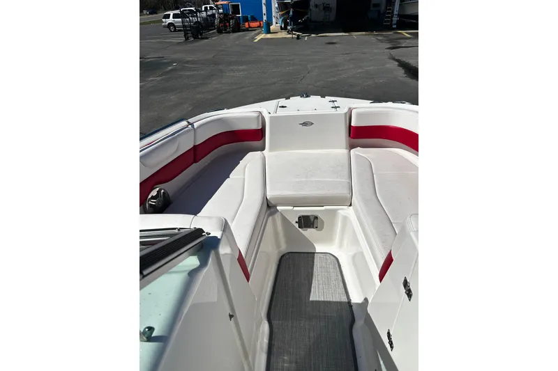 Slide: The Image of 2016 Chaparral 210 Suncoast boat interior with red and white seating. - 9