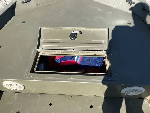 Slide: The Image of 2021 Tracker TRACKER 1860 MVX boat with open storage compartment. - 12