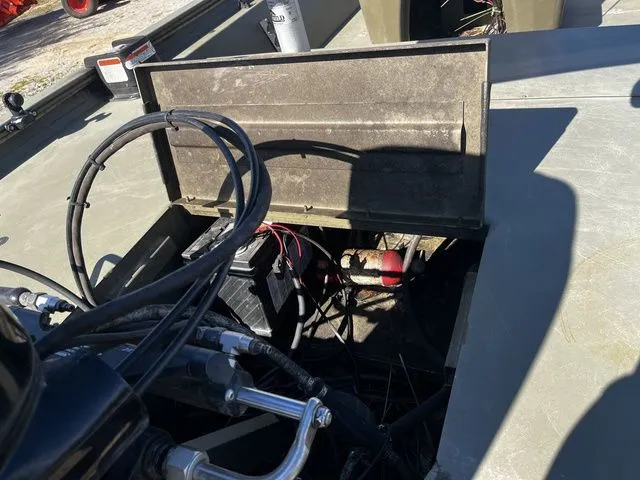 Slide: The Image of 2021 Tracker 1860 MVX boat engine compartment with cables and battery. - 16