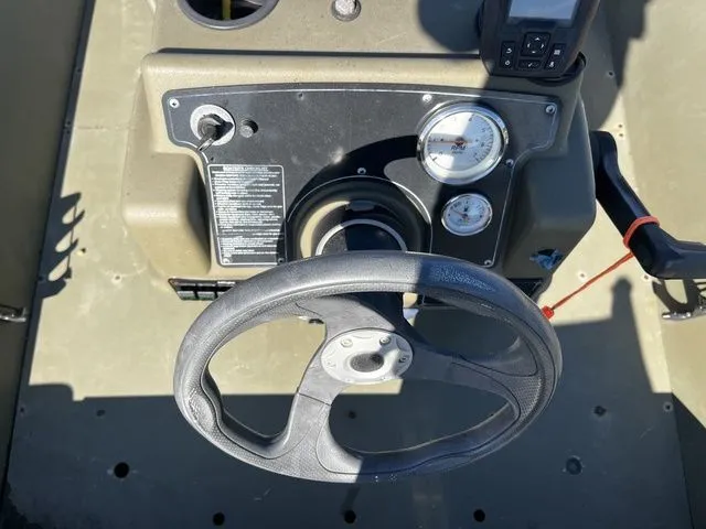 Slide: The Image of Steering wheel and dashboard of a 2021 Tracker 1860 MVX boat. - 8