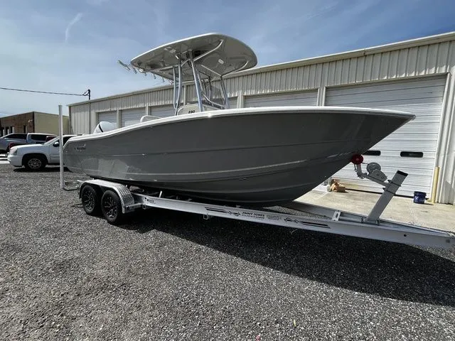 Slide: The Image of 2026 Bulls Bay 230CC boat on trailer in front of garage. - 2