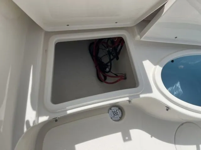 Slide: The Image of Open storage compartment in 2026 Bulls Bay 230CC boat with cables. - 21