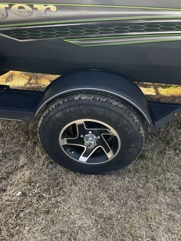 Slide: The Image of Close-up of a 2021 Ranger RT188P boat trailer on grass. - 16