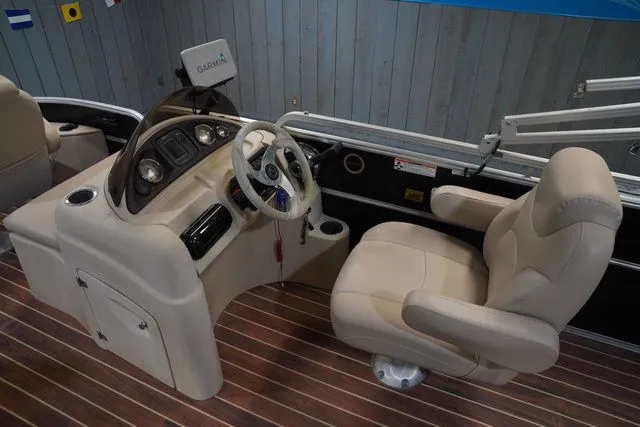 Slide: The Image of Interior of a 2015 South Bay 424FCR boat with steering console. - 16