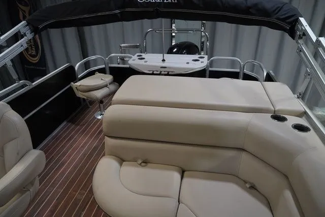 Slide: The Image of Interior of a 2015 South Bay 424FCR pontoon boat with beige seating. - 18