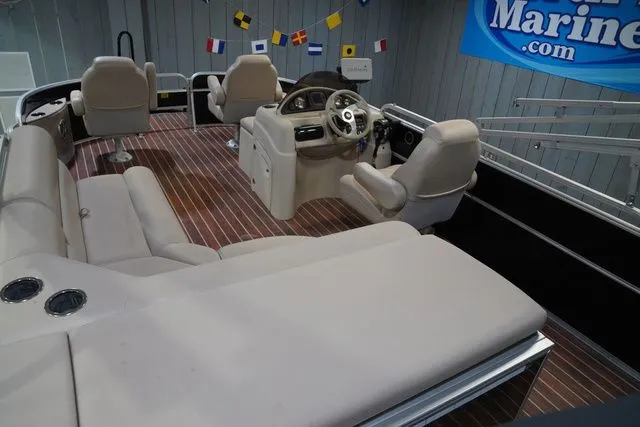 Slide: The Image of Interior of a 2015 South Bay 424FCR pontoon boat with beige seating. - 21