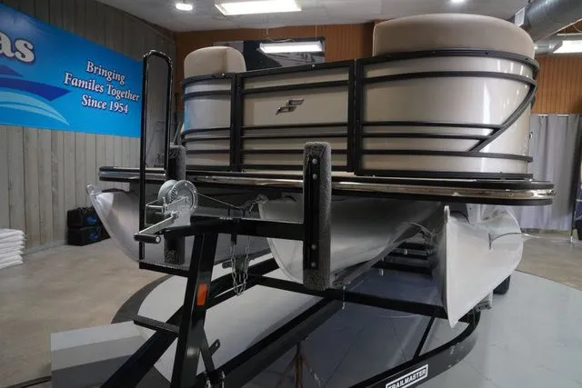 Slide: The Image of 2024 Starcraft SLS 3 Q DH pontoon boat on trailer in showroom. - 3