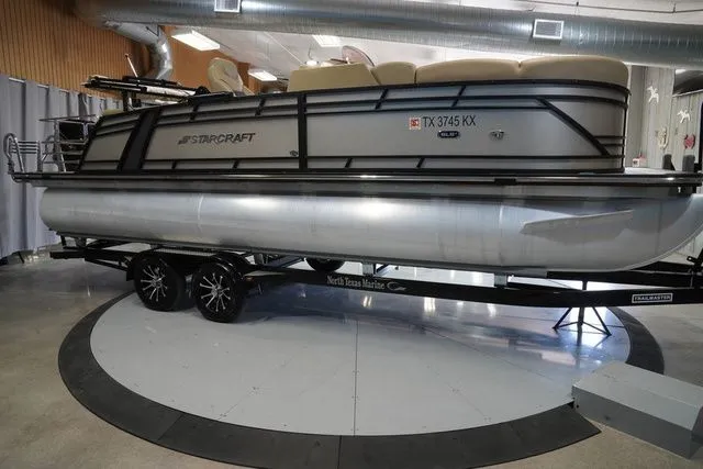Slide: The Image of 2024 Starcraft SLS 3 Q DH pontoon boat on trailer in showroom. - 6