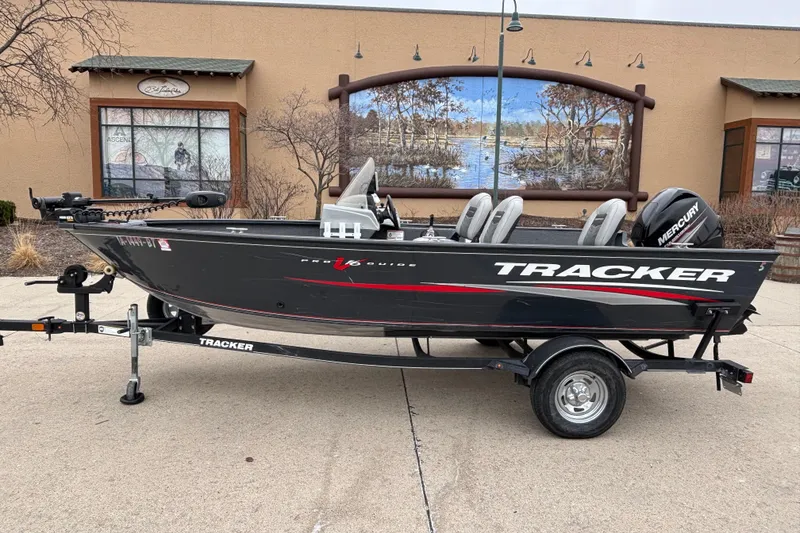 The Image of 2019 Tracker Pro Guide V-16 SC boat on trailer, parked outdoors. - 0