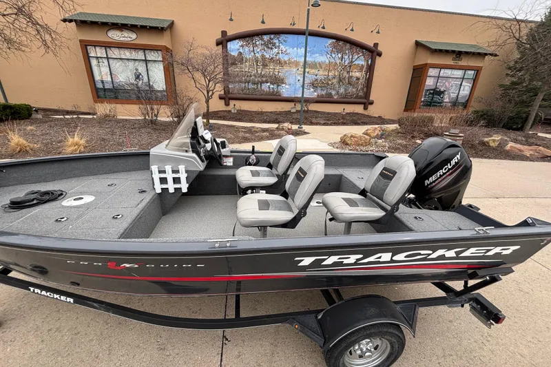 Slide: The Image of 2019 Tracker Pro Guide V-16 SC boat with Mercury engine, parked outdoors. - 4