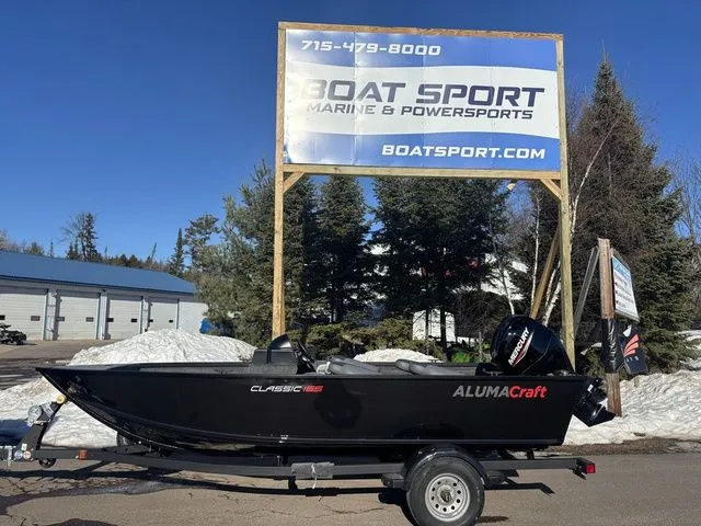 The Image of 2026 Alumacraft Classic 165 Side Console boat in front of Boat Sport sign. - 1