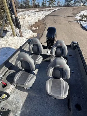 Slide: The Image of 2026 Alumacraft Classic 165 Side Console with four seats on snowy road. - 11