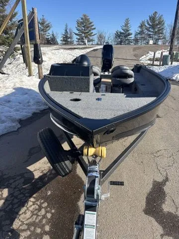 Slide: The Image of 2026 Alumacraft Classic 165 Side Console boat on trailer outdoors. - 3