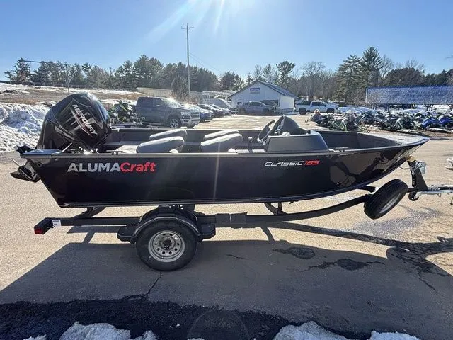 Slide: The Image of 2026 Alumacraft Classic 165 Side Console boat on trailer. - 5