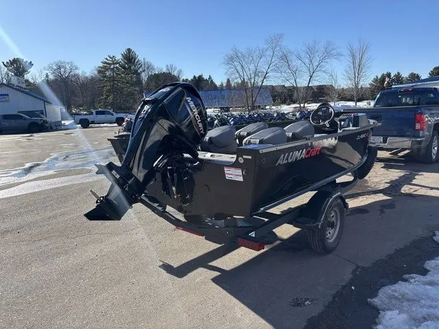 Slide: The Image of 2026 Alumacraft Classic 165 Side Console boat on trailer outdoors. - 6