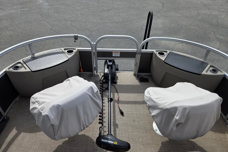 Slide: The Image of 2023 Sun Tracker Fishin' Barge 22 DLX deck with covered seats and trolling motor. - 12