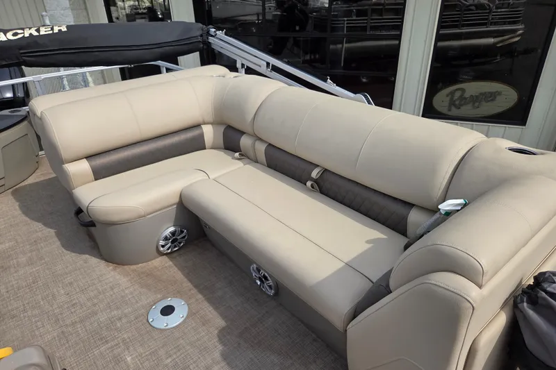 Slide: The Image of 2023 Sun Tracker Fishin' Barge 22 DLX with beige seating and cup holders. - 9